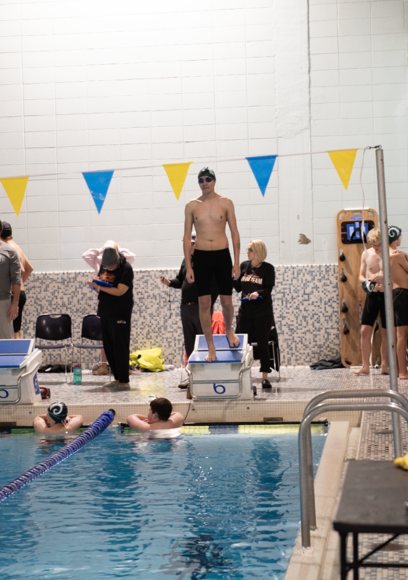 1.20.25 Junior Ronan O’Neill steps up onto the block before swimming the 100 yard free at the senior recognition meet. 